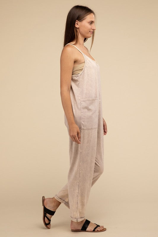 Woman standing and posing in a studio, wearing casual comfort style green Washed Spaghetti Straps Overalls with Pockets and sandals.