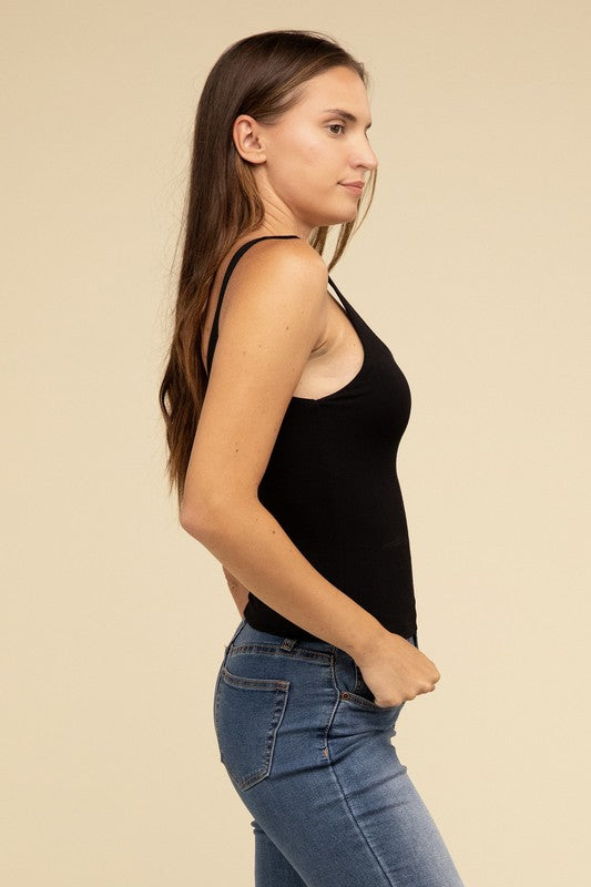 Dressed in a Double Layer Round Neck Tank Top and jeans, the person exudes stylish comfort while standing against a beige background.