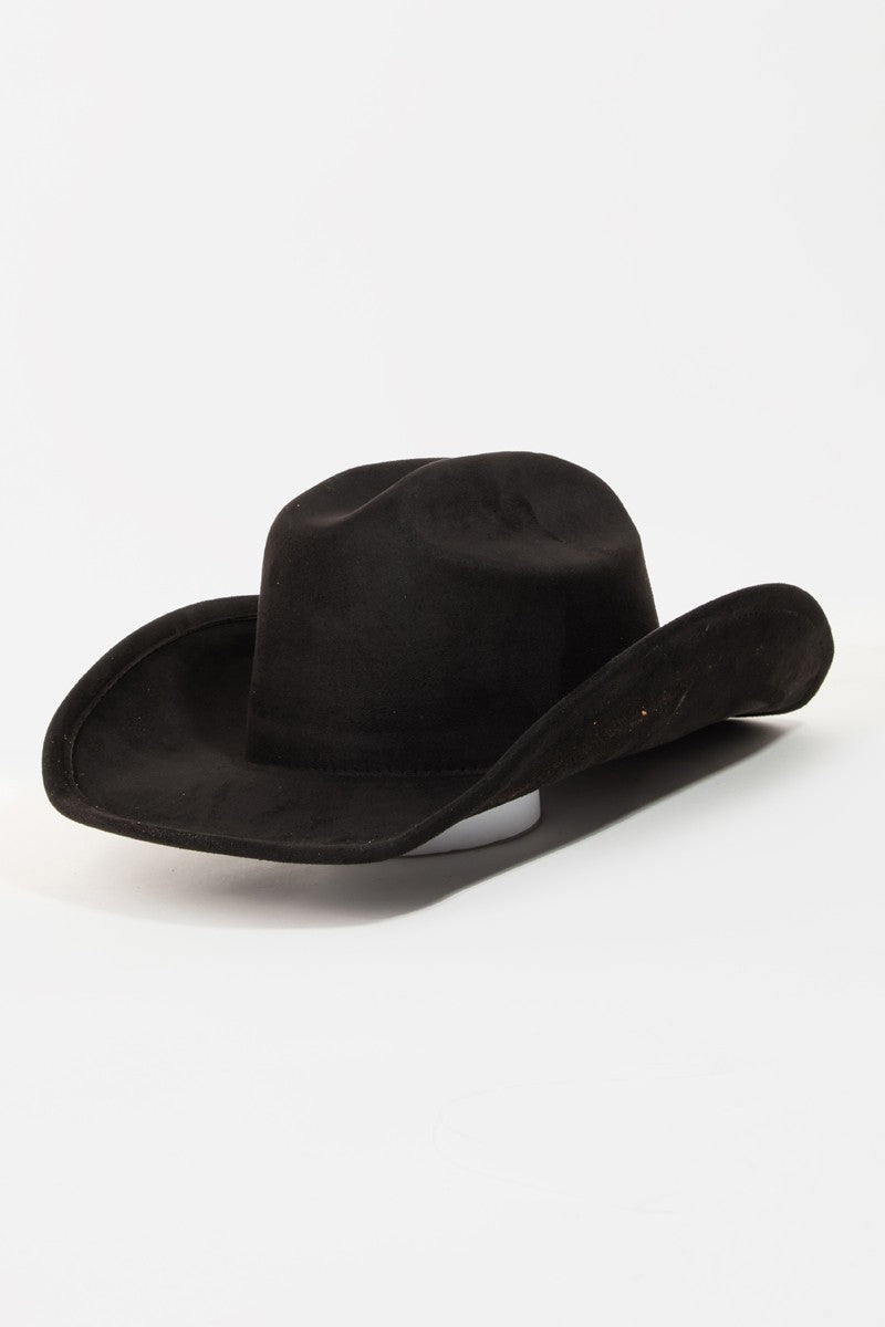 The Fame Solid Wide Brim Hat, showcasing a classic western style with its wide brim and creased crown, sits elegantly on a white surface.