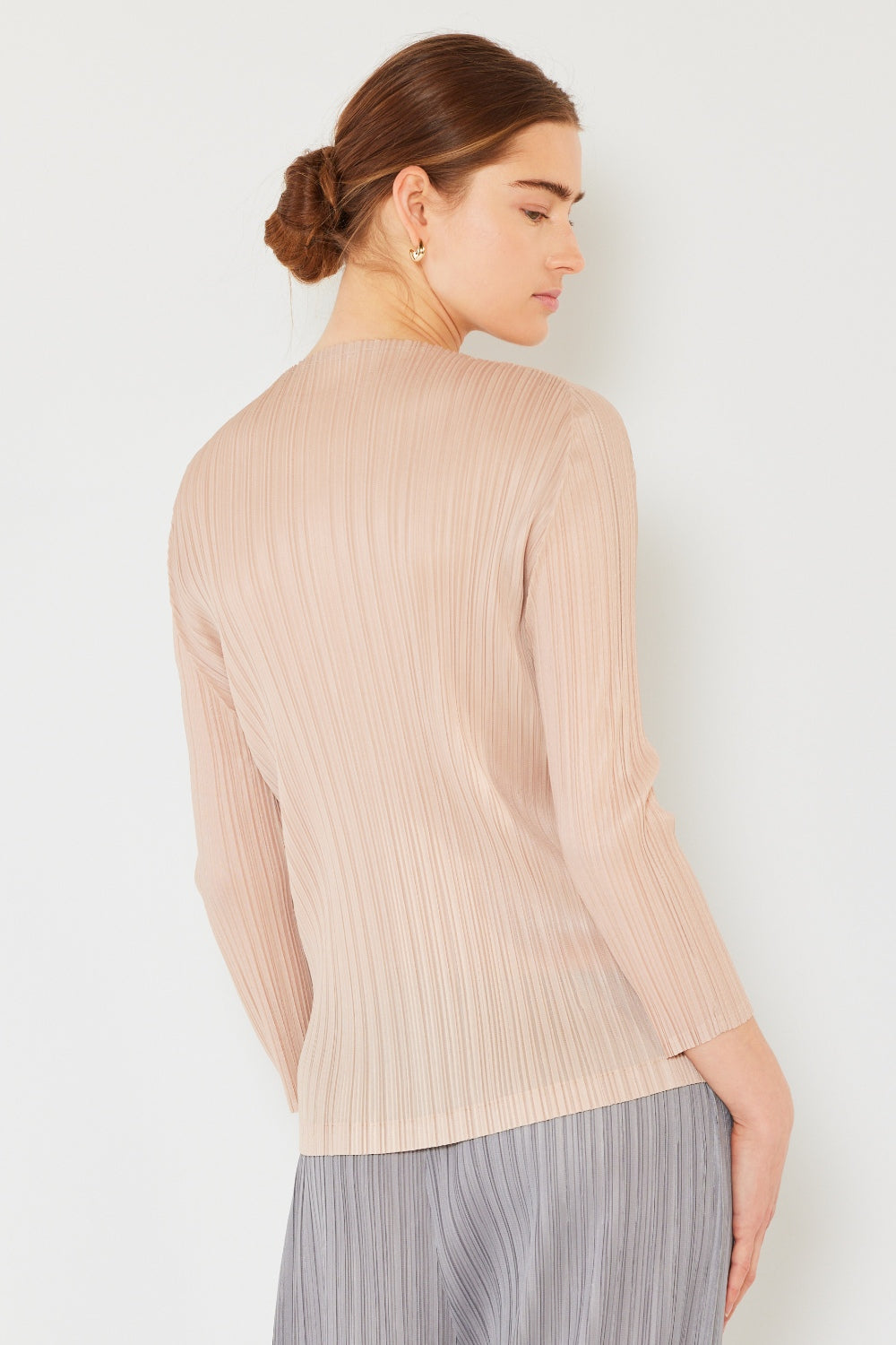 A person wearing the Marina West Swim Pleated Long Sleeve Boatneck Top with matching pants stands against a plain background.