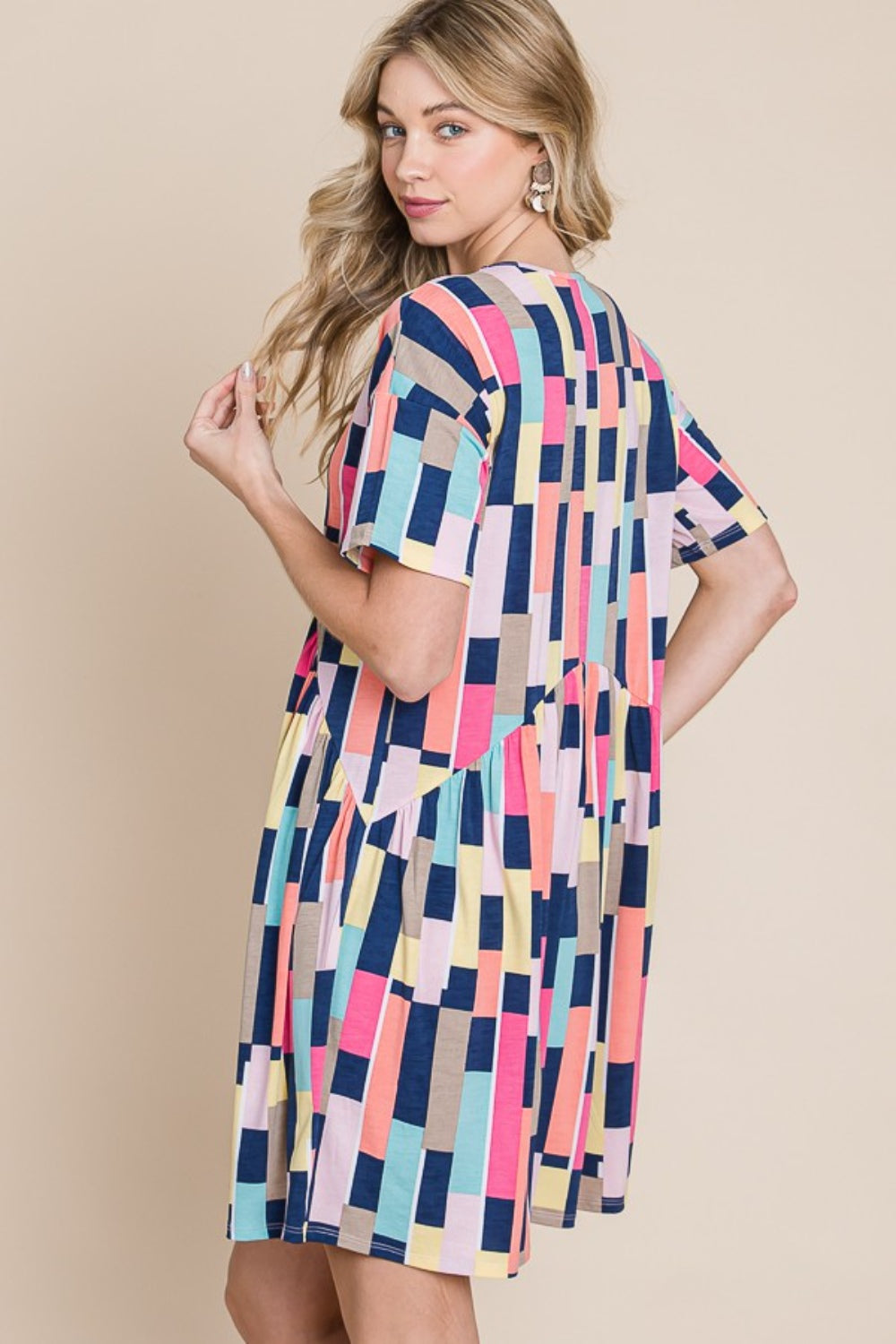 Person wearing the BOMBOM Ruched Color Block Short Sleeve Mini Dress and a straw hat, standing against a beige background, smiling.