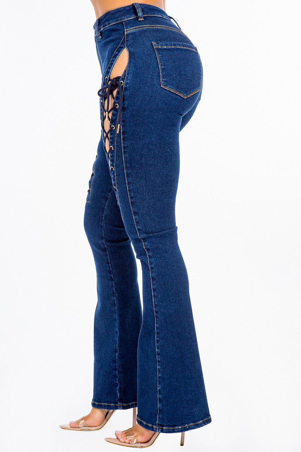 A pair of American Bazi High Rise Lace Up Jeans, featuring stylish denim and side detailing, worn by a person.