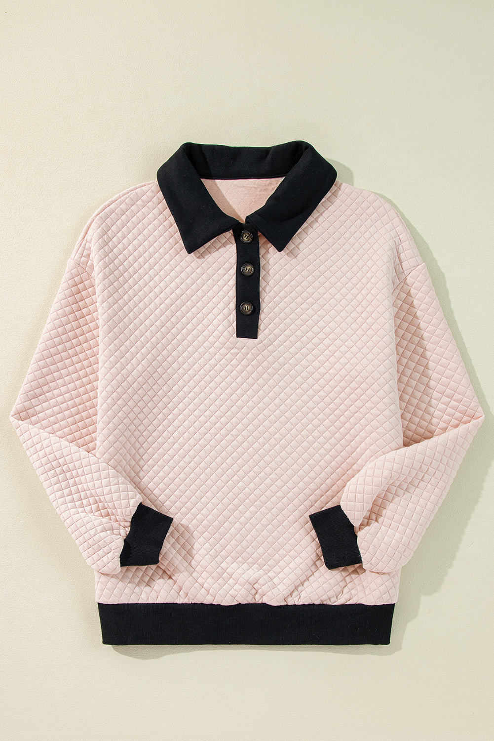 A person wearing an Oatmeal Textured Colorblock Edge Buttoned Collar Sweatshirt, paired with blue jeans, stands with their back to the camera against a white backdrop. The trendy sweatshirt features stylish textured fabric and buttoned collars that add an extra touch of sophistication.