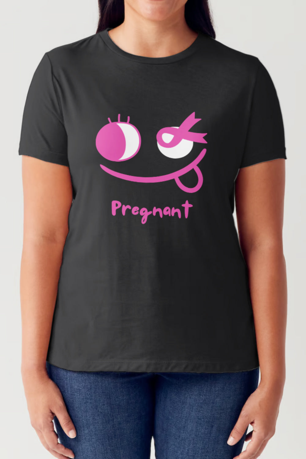 A person wearing the Simply Love Full Size Graphic Short Sleeve Round Neck Tubular T-Shirt, which features a pink winking face graphic and the word "Pregnant" beneath it, made with tubular construction.