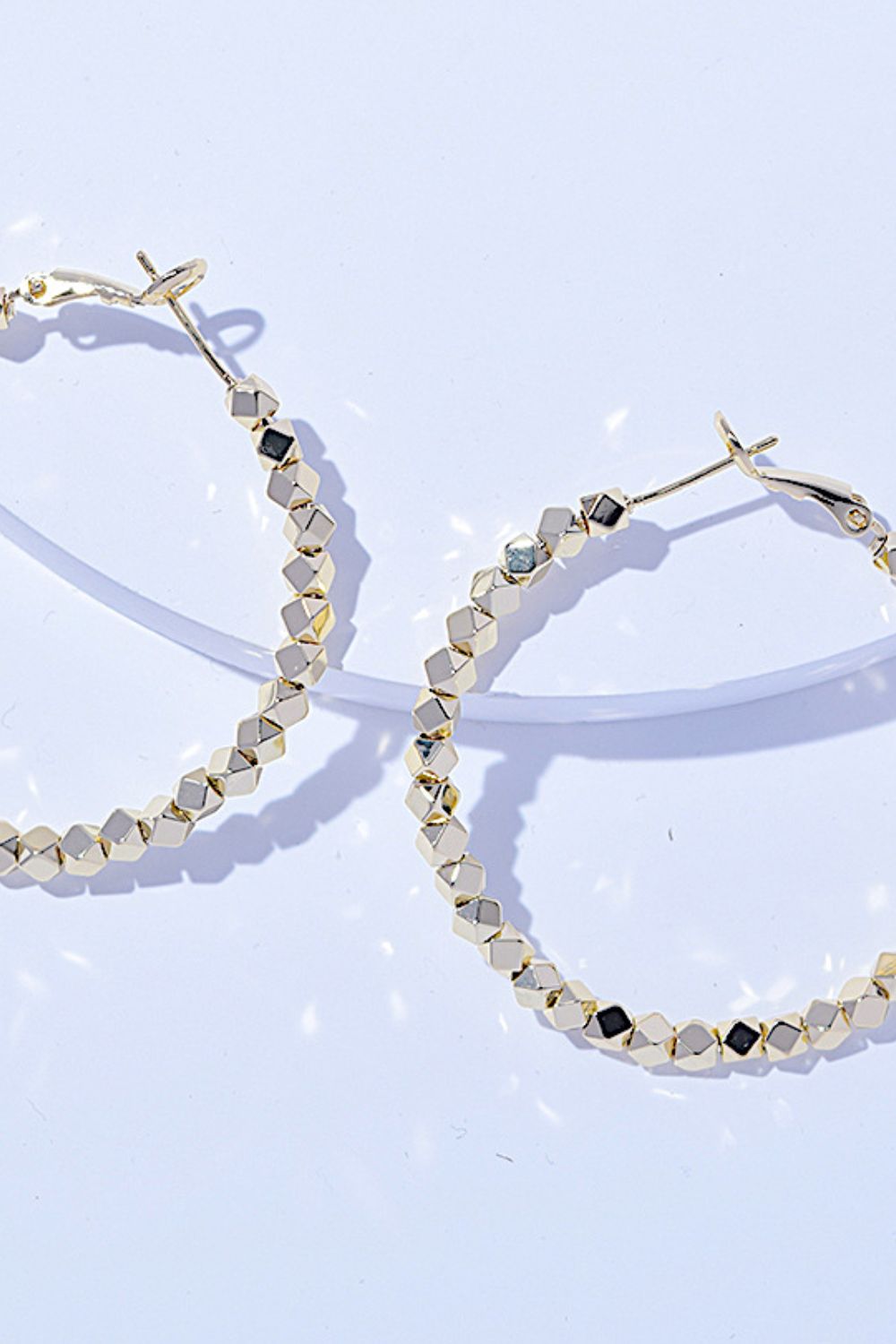 A pair of Alloy Hoop Earrings with a beaded design, displayed on a white background.