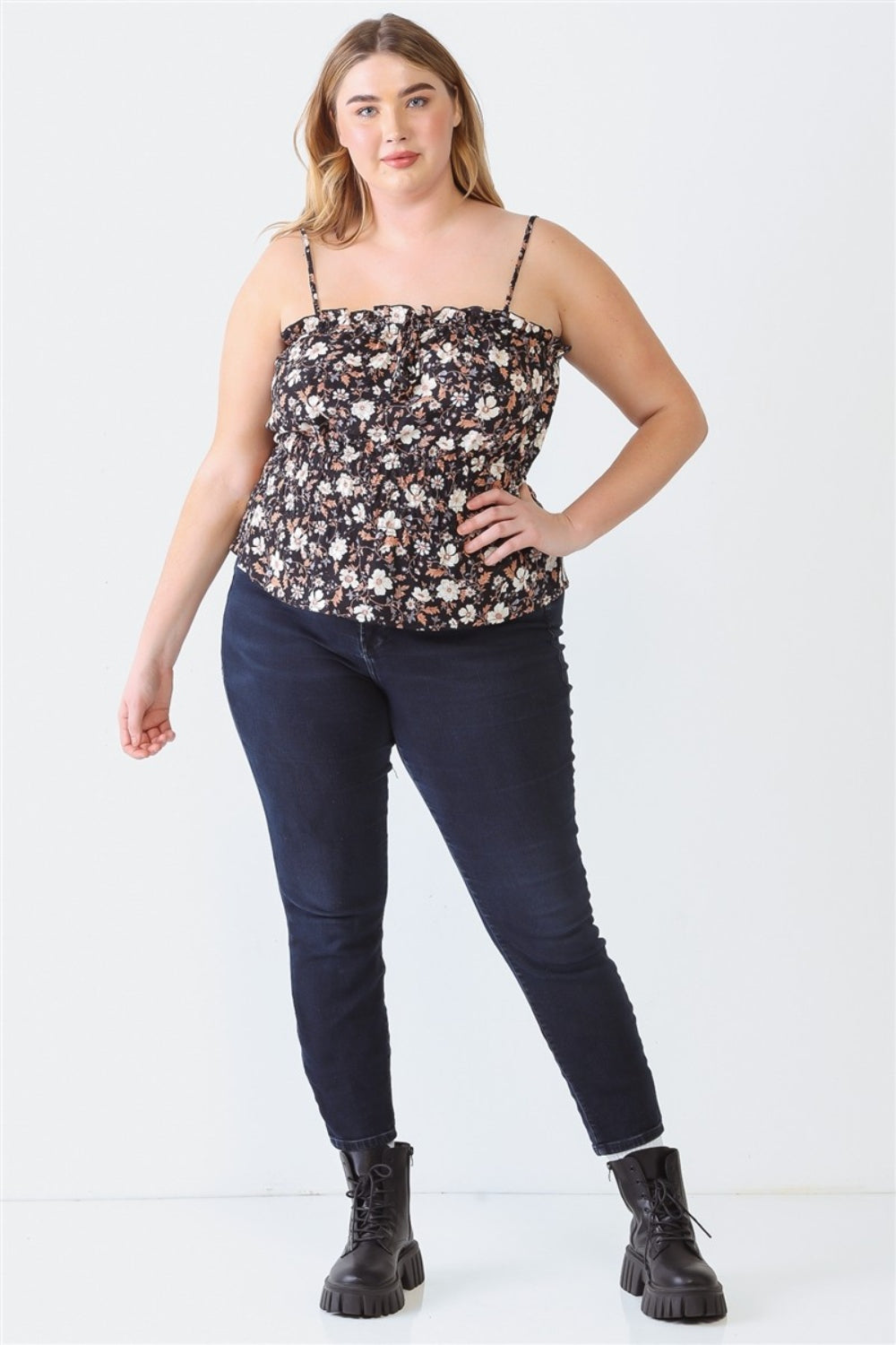 A person with long hair, wearing the Zenobia Plus Size Frill Floral Square Neck Cami and dark jeans, stands with one hand on their hip and the other relaxed by their side.