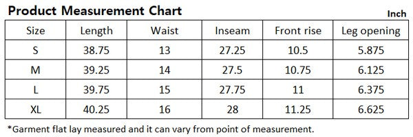 A person wearing a white sweater and black Vegan leather pants with hands in the pockets.