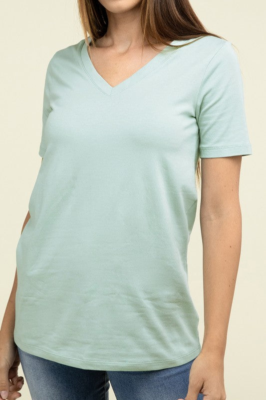 A person with long hair is standing and wearing a light blue Cotton V-Neck Short Sleeve T-Shirt and black pants.