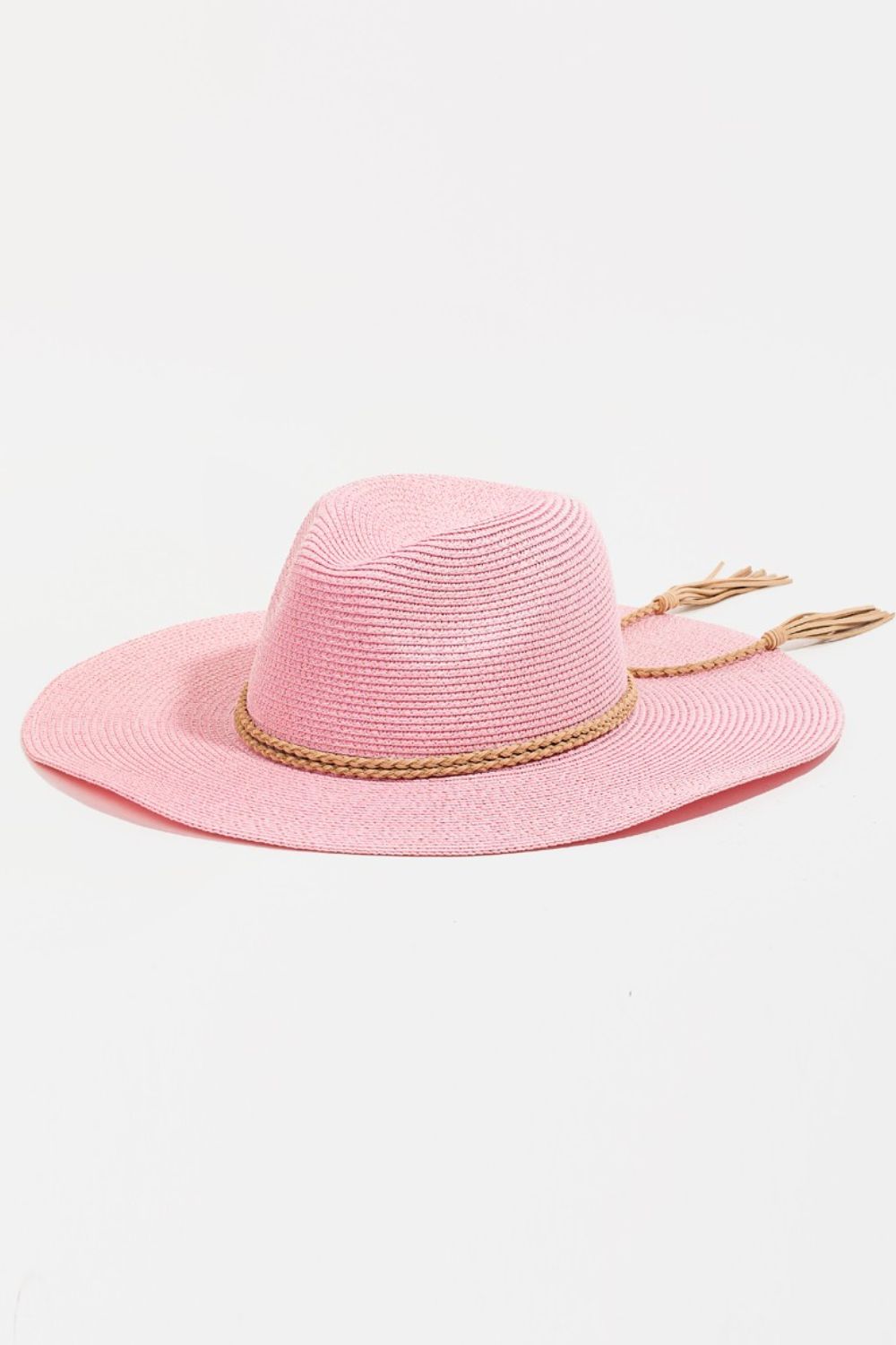 The Fame Straw Braided Rope Strap Fedora Hat exudes bohemian charm with its wide-brimmed design, pink straw material, braided rope trim, and tassel details, all beautifully displayed on a neutral background.