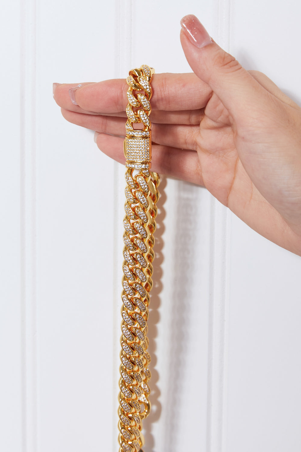 Brass Curb Chain Necklace elegantly displayed on a light blue round surface.