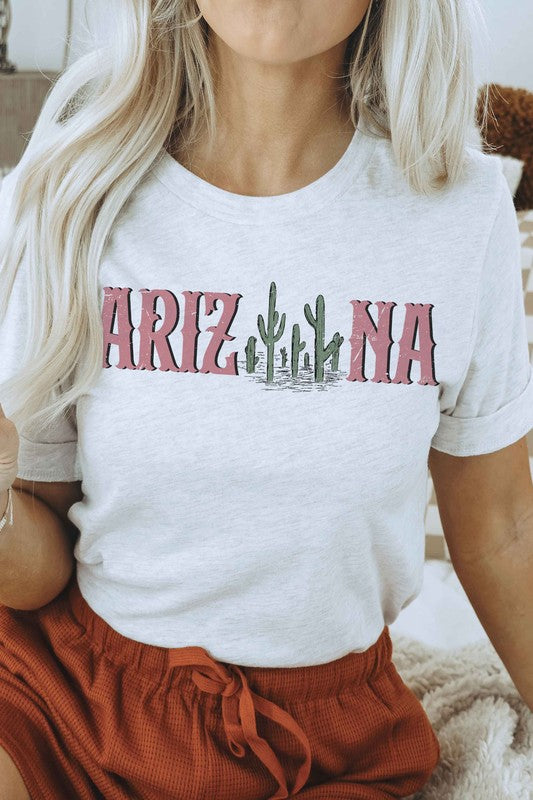 Individual clad in a white ARIZONA CACTUS Graphic Tee, constructed from 100% airlume combed and ringspun cotton, coupled with light blue jeans. Unisex sizing guarantees an ideal fit for everyone.