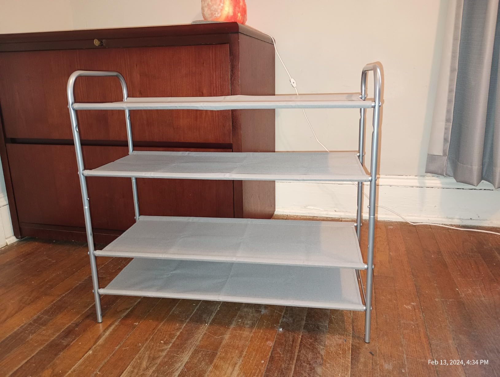 A modern Simple Houseware 4-Tier Shoe Rack Storage Organizer 20-Pair, Grey made of metal with gray fabric shelves.