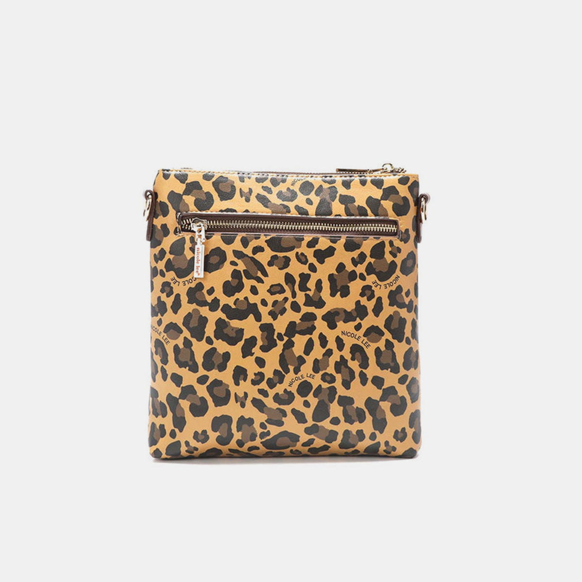 The Nicole Lee USA Leopard crossbody bag is made from vegan leather and showcases a leopard print design. It features a front pocket, a zippered closure, gold-tone hardware, brown trim, and a black panel at the top that is embellished with a brand label.