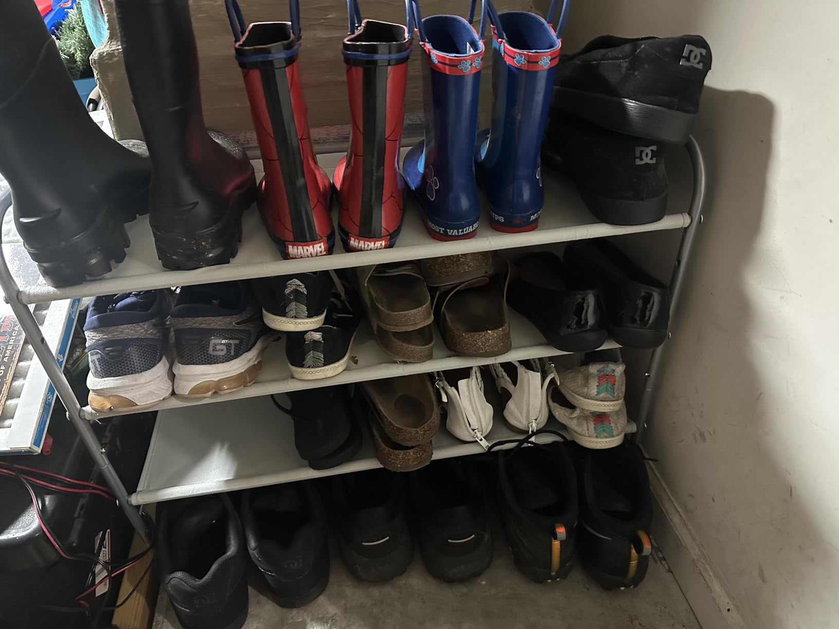 A modern Simple Houseware 4-Tier Shoe Rack Storage Organizer 20-Pair, Grey made of metal with gray fabric shelves.