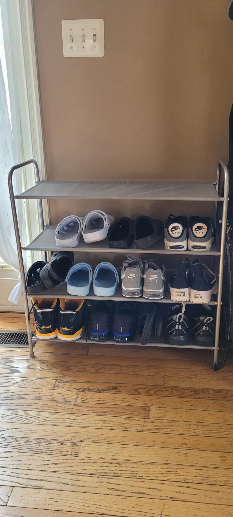 A modern Simple Houseware 4-Tier Shoe Rack Storage Organizer 20-Pair, Grey made of metal with gray fabric shelves.
