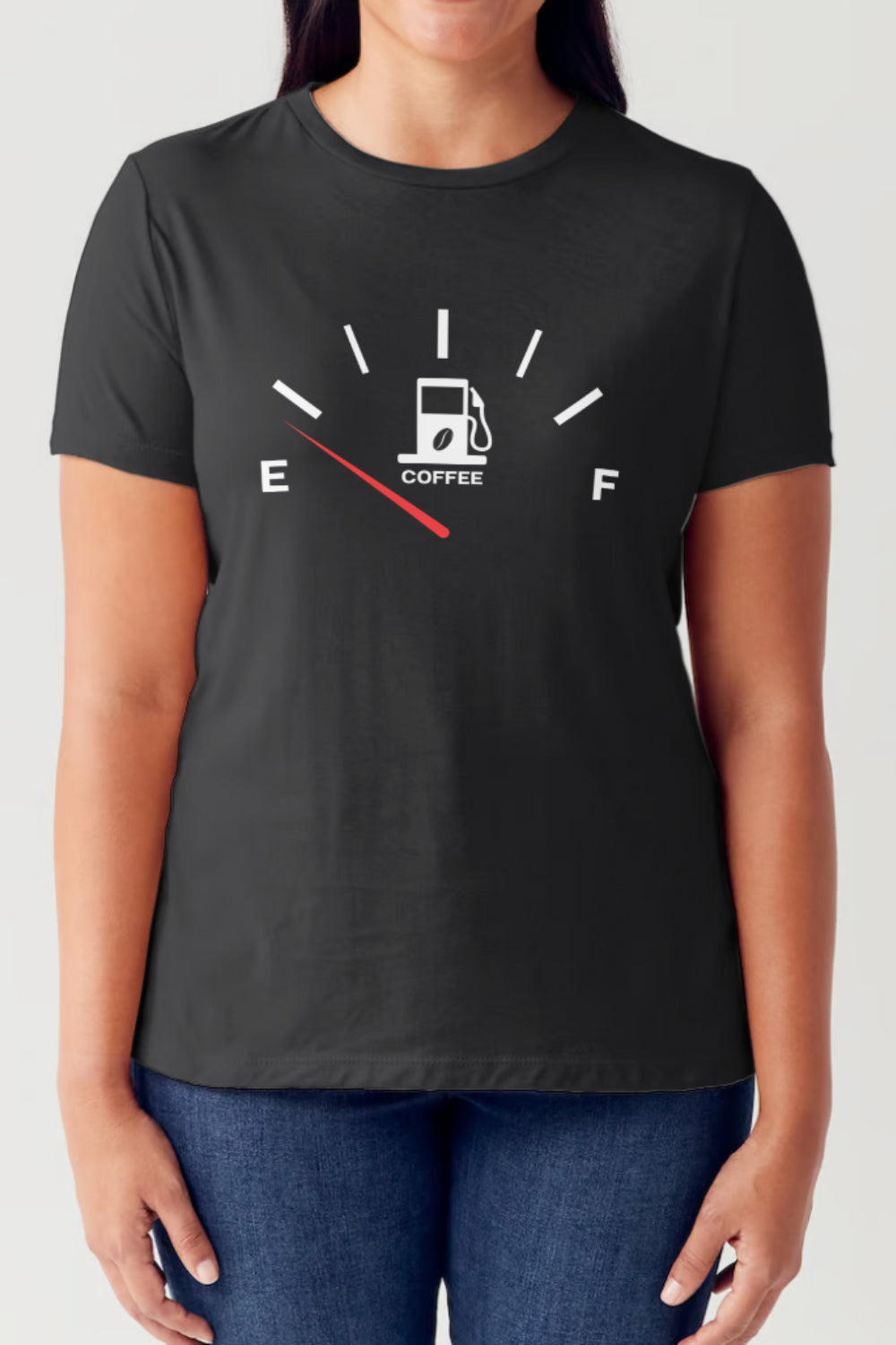 A coffee lover is wearing the Simply Love Full Size Coffee Fuelled Graphic Short Sleeve Tubular T-Shirt in black, which displays a fuel gauge with a coffee cup at the center and the needle pointing to 'E'. The 100% ringspun combed cotton material ensures comfort and style.