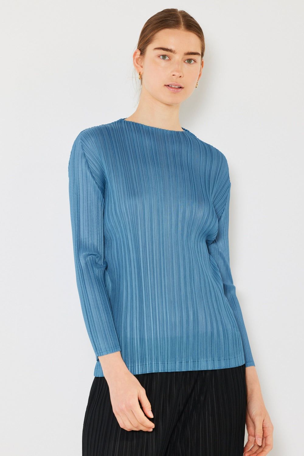 A person wearing the Marina West Swim Pleated Long Sleeve Boatneck Top with matching pants stands against a plain background.