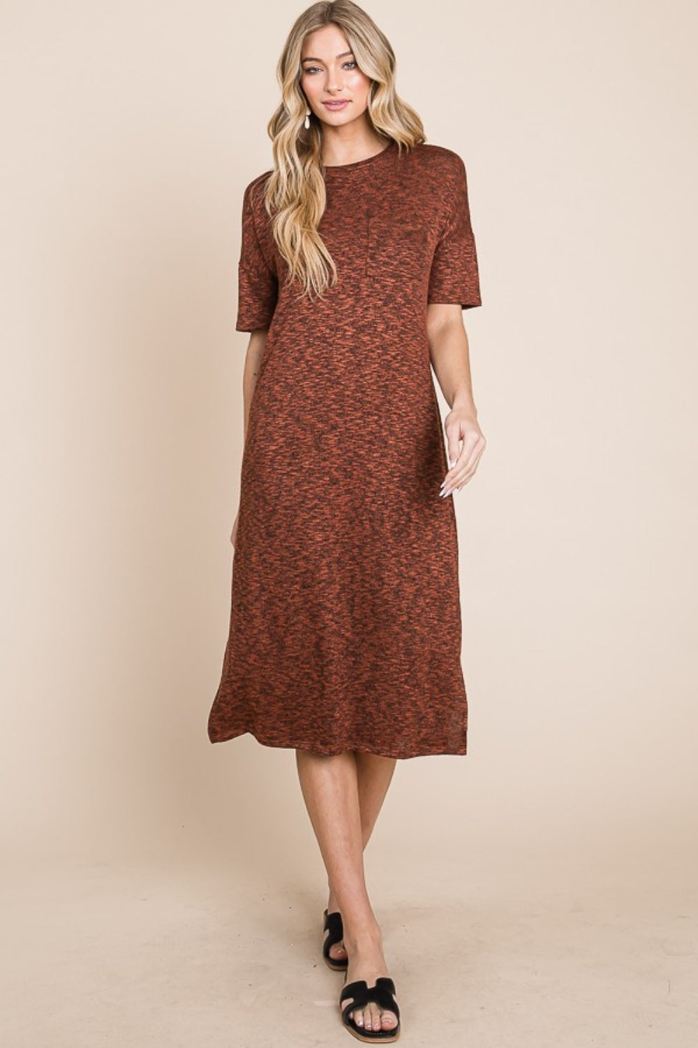 A person with long, wavy hair wearing the BOMBOM Round Neck Side Slit Midi Dress in brown and black sandals stands against a plain background.