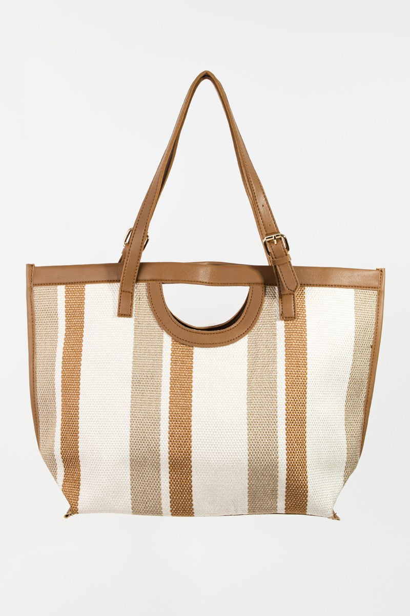 The Fame Striped PU Leather Trim Tote Bag, showcasing beige and brown stripes with leather handles and an adjustable strap, is the ideal fashionable accessory to complement any outfit.