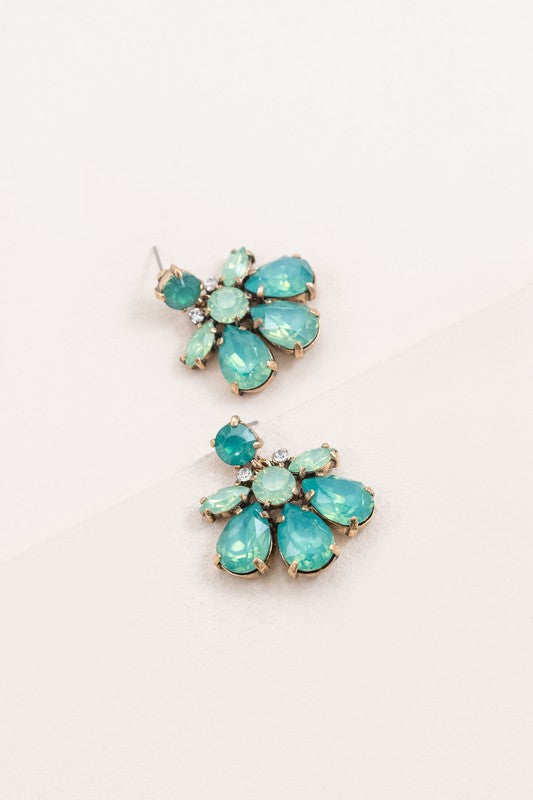 A pair of Water Lily Stone Earrings with iridescent green stones against a white background.