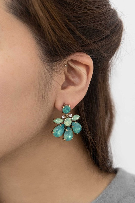 A pair of Water Lily Stone Earrings with iridescent green stones against a white background.