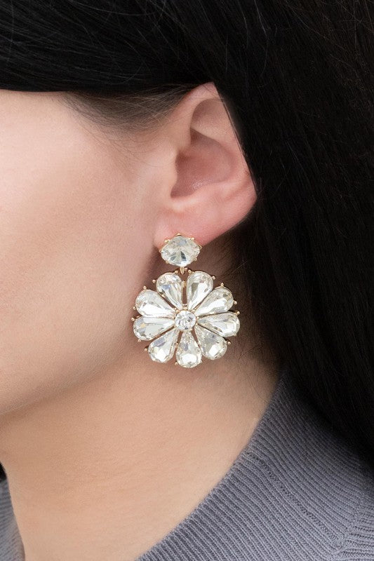 Pair of Fleur Drop Earrings on a white surface.