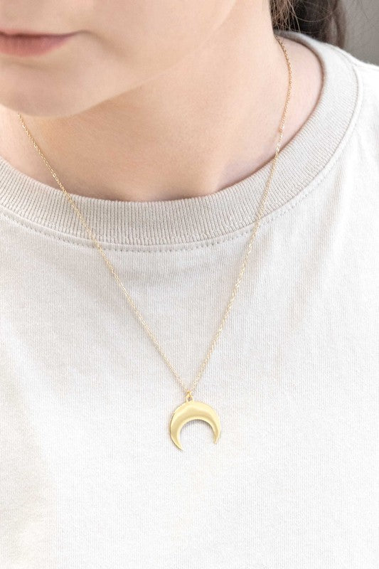 A delicate Moonglade Necklace 14K Gold with a crescent moon charm pendant displayed on a white surface.