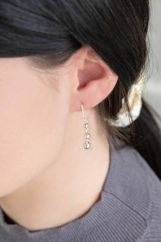 A pair of Stuck in Time Hook Earrings sterl on a light background.