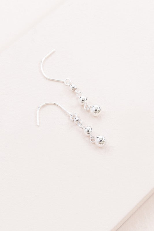 A pair of Stuck in Time Hook Earrings sterl on a light background.