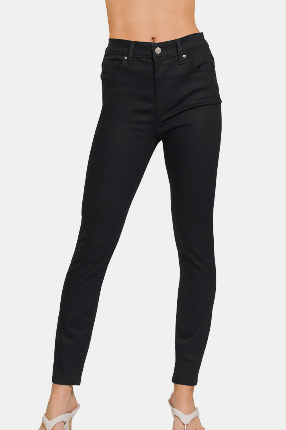 A person wearing the Zenana Full Size High-Rise Skinny Jeans with a slimming effect.