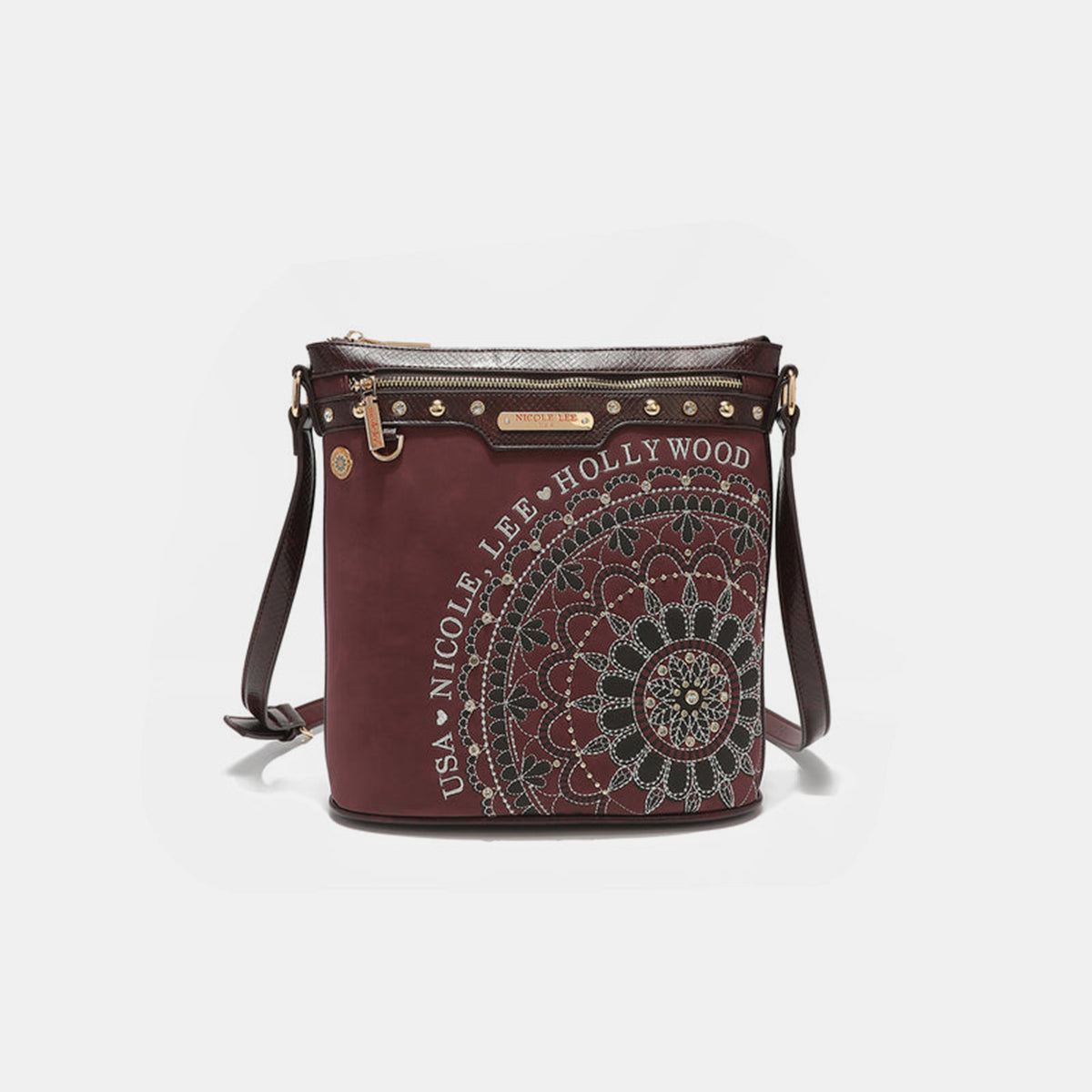 The Nicole Lee USA Metallic Stitching Embroidery Inlaid Rhinestone Crossbody Bag is a brown vegan leather accessory adorned with intricate white designs and text reading "Nicole Lee Hollywood USA" on the front. It features diamond rhinestones, multiple zippered compartments, and an adjustable strap.