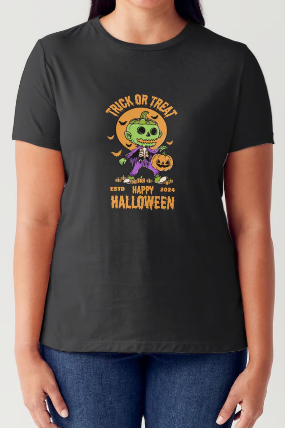 A person wearing a Simply Love Full Size TRICK OR TREAT Round Neck Short Sleeve Tubular T-Shirt in white, featuring a Halloween-themed design with a green skeleton, the text "Trick or Treat", "Happy Halloween 2024", and a pumpkin illustration.