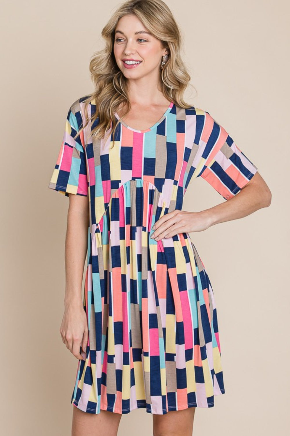 Person wearing the BOMBOM Ruched Color Block Short Sleeve Mini Dress and a straw hat, standing against a beige background, smiling.