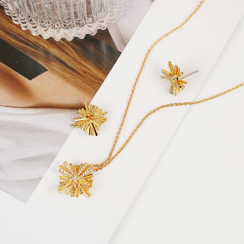 A breathtaking Starburst Gold-Plated Earrings and Necklace Set adorned with shimmering zircon accents.