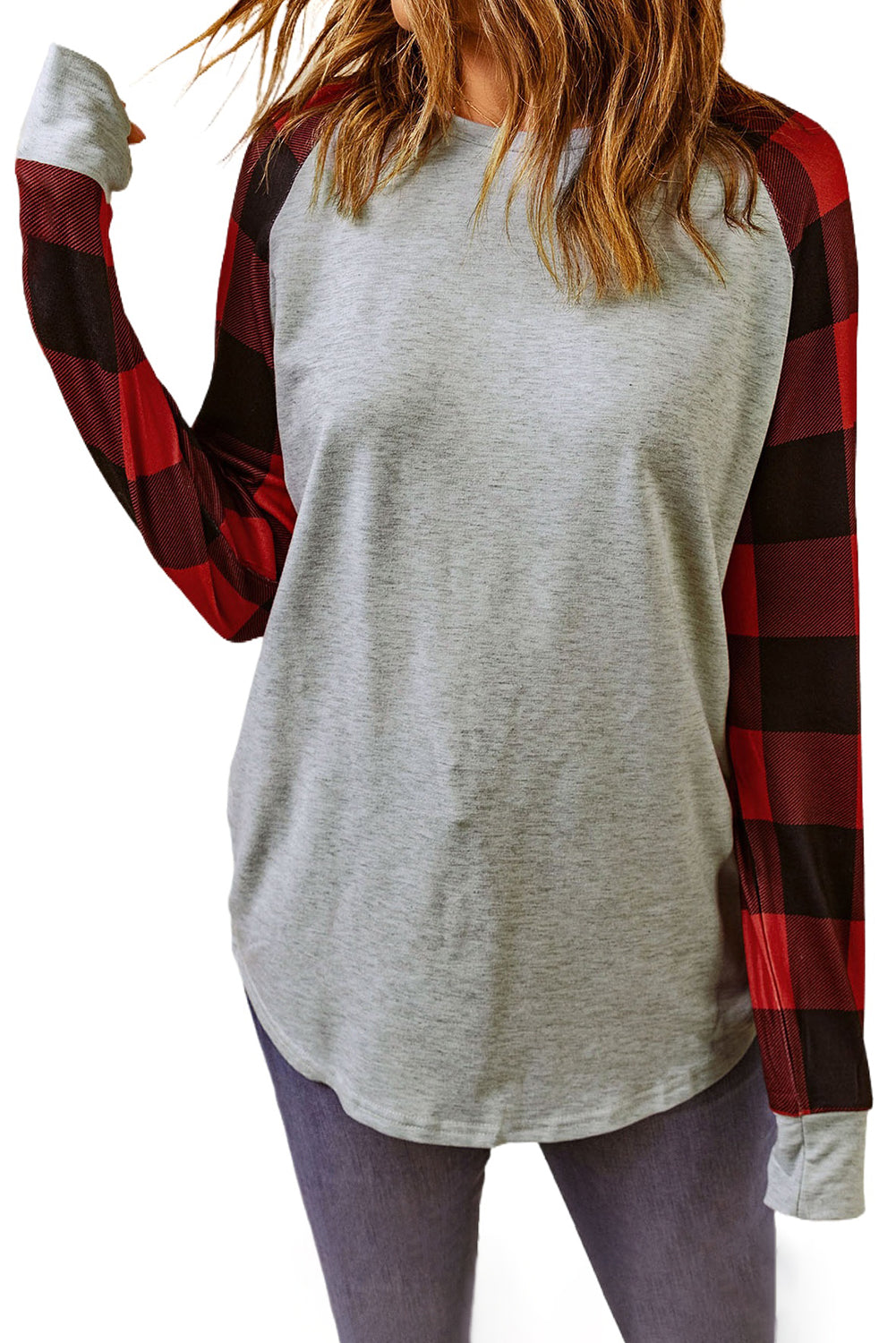 A person with wavy, brown hair is standing with their back to the camera, wearing a Gray Buffalo Plaid Long Sleeve Sweatshirt and blue jeans.