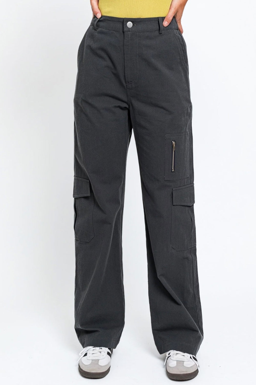   Person wearing the Le Lis High Waisted Wide Leg Cargo Pants with Pockets, featuring side pockets and zipper details, standing against a plain white background.