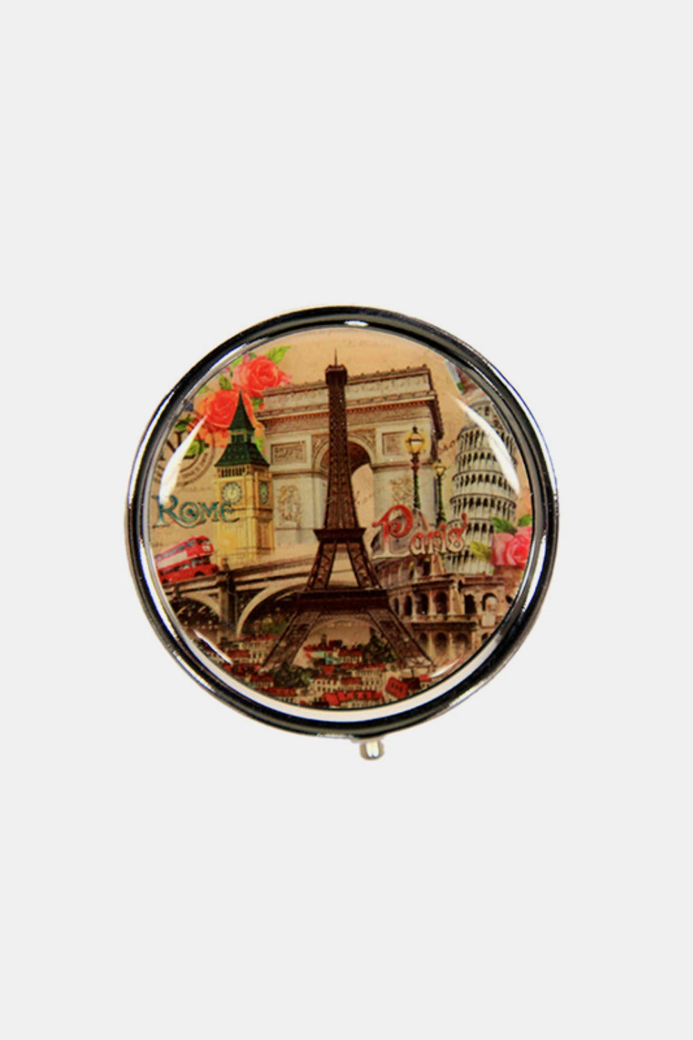 The Nicole Lee USA Print Metallic Circular Small Pill Case holds a metal pin that showcases an illustration of a dog and cat driving a red convertible through a city adorned with iconic buildings and landmarks, all wrapped in a sleek silver-tone metal exterior.