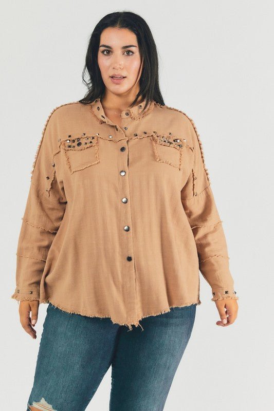 A person with dark hair wearing a Plus Distressed Hem Button Down Oversize Shirt and jeans stands against a light background, embodying casual comfort.