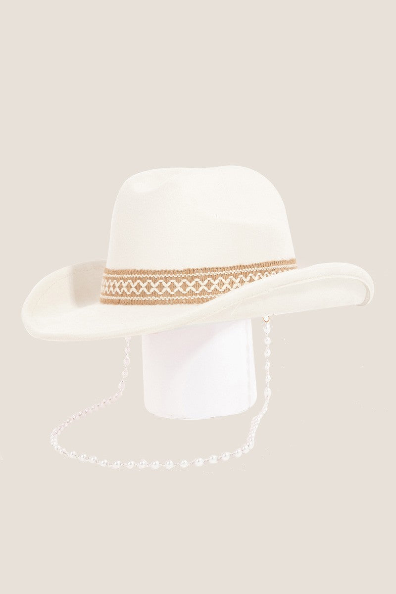 Fame Ornate Band Cowboy Hat in light pink features an intricate band around the crown and a pearl chain elegantly draped from the side, offering a distinctive look.