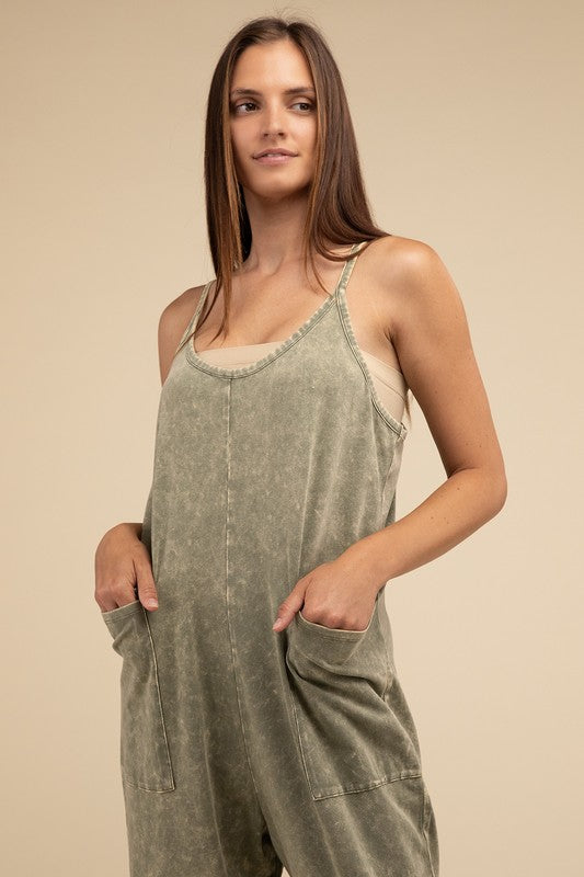 Woman standing and posing in a studio, wearing casual comfort style green Washed Spaghetti Straps Overalls with Pockets and sandals.