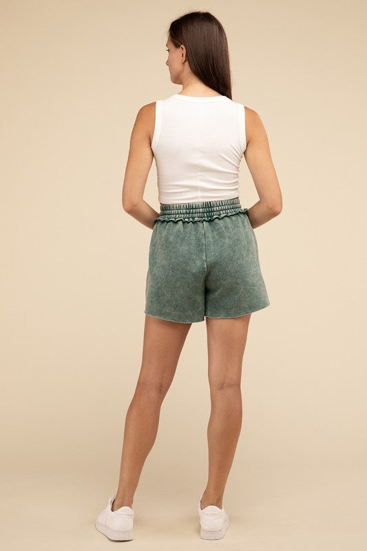 Person wearing a white crop top and green Acid Wash Fleece Drawstring Shorts with Pockets, standing against a plain background.