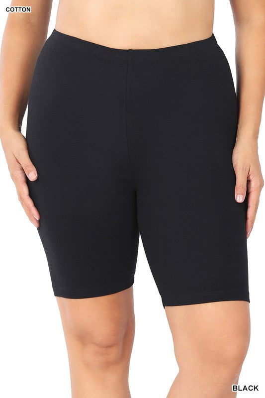 Close-up of a person wearing Plus Premium Cotton Biker Shorts made from stretchy fabric. The person's hands rest at their sides, highlighting the comfort and flexibility of this activewear.