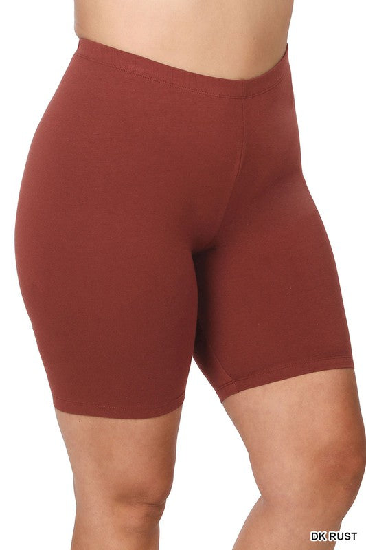 Close-up of a person wearing Plus Premium Cotton Biker Shorts made from stretchy fabric. The person's hands rest at their sides, highlighting the comfort and flexibility of this activewear.