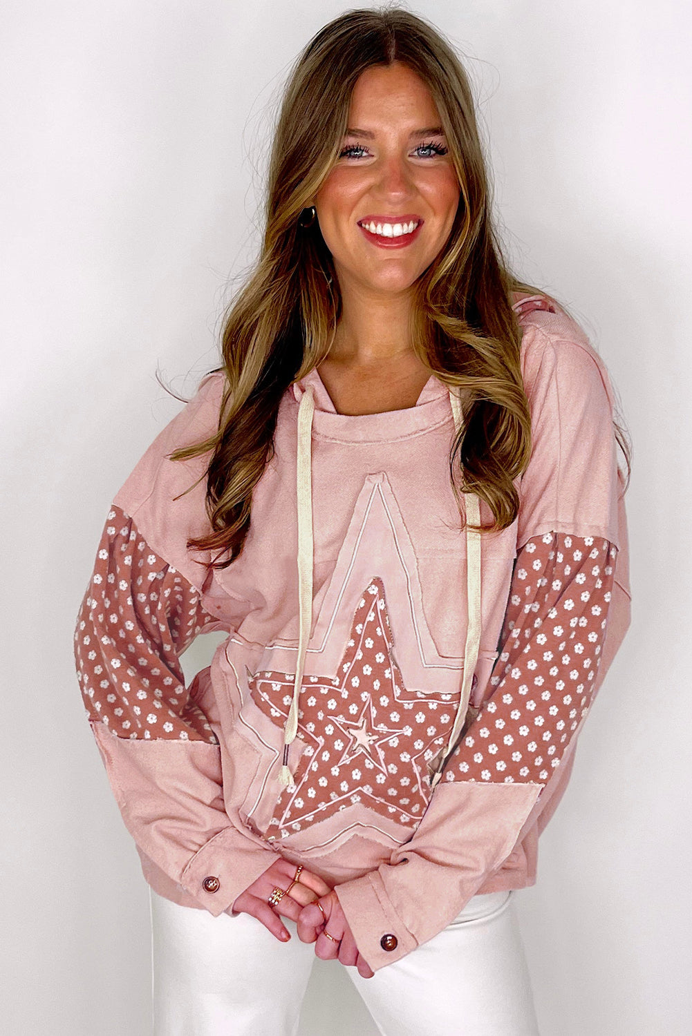 Person wearing the Delicacy Floral Patchwork Star Pattern Drawstring Hoodie, showcasing the floral patchwork design on the hood and sleeves from the back.