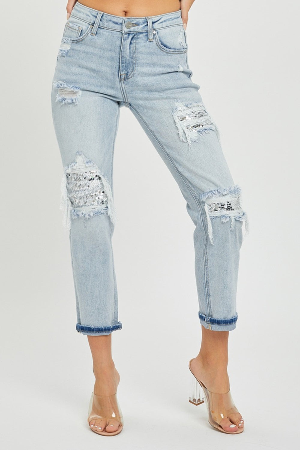 Person wearing RISEN Mid-Rise Sequin Patched Jeans and clear high-heeled sandals, against a plain background.