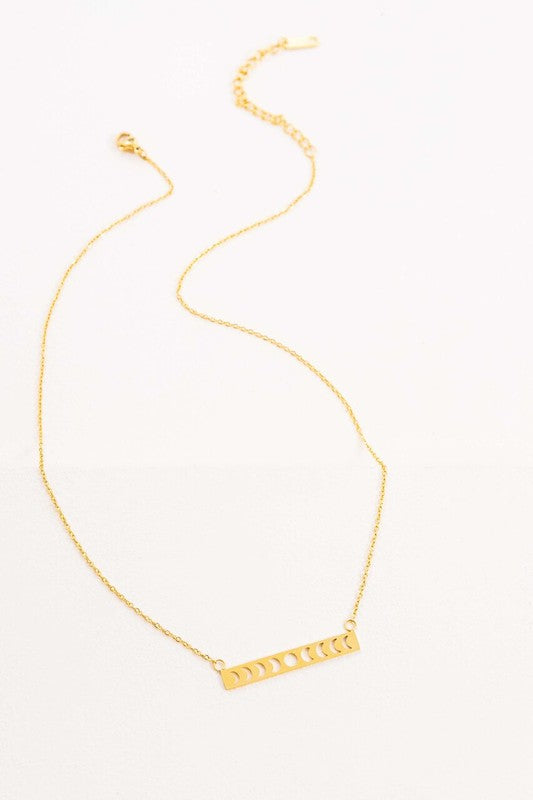 Lunar Phase Bar Necklace with an 18K gold over stainless steel bar pendant on a white background.