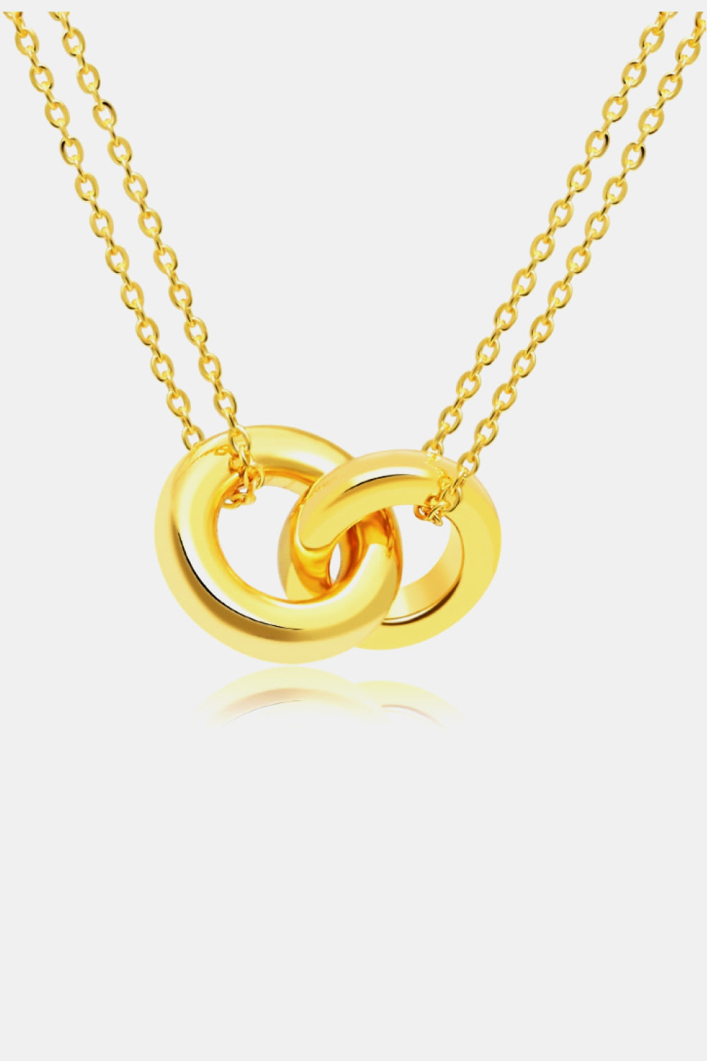 The Linked Ring Pendant Chain Necklace showcases an elegant design with a gold pendant featuring two interlocking circles.