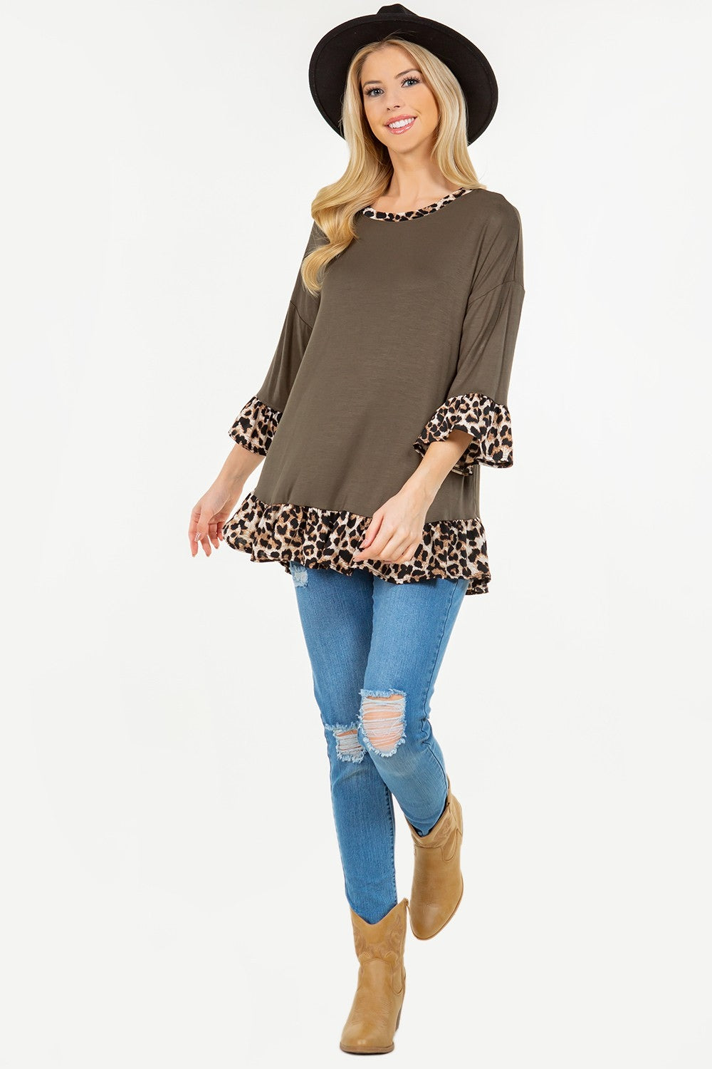 Person wearing the Celeste Full Size Flounce Sleeve Leopard Trim Top in brown, paired with blue jeans and a black hat, posing elegantly against a plain background.