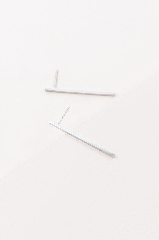Boss Status Bar Earrings on a white textured surface.