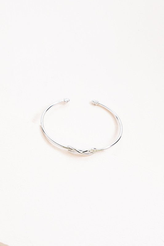 Infinity cuff bracelet on a white background.